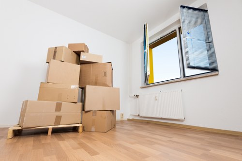 Local small removals team transporting furniture and boxes